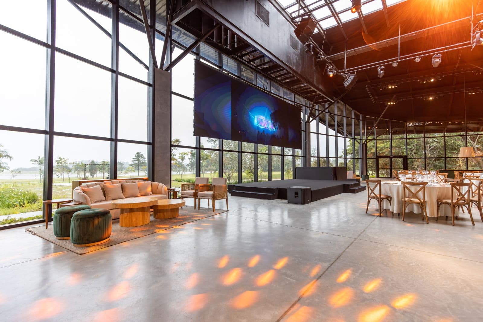 Empty conference hall with a large projection screen and stage lighting