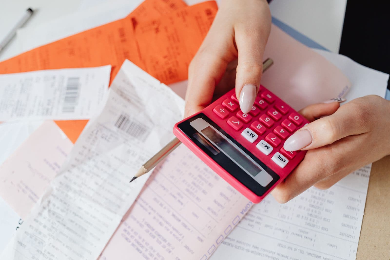 Close up of a hand using a calculator to work through an event budget