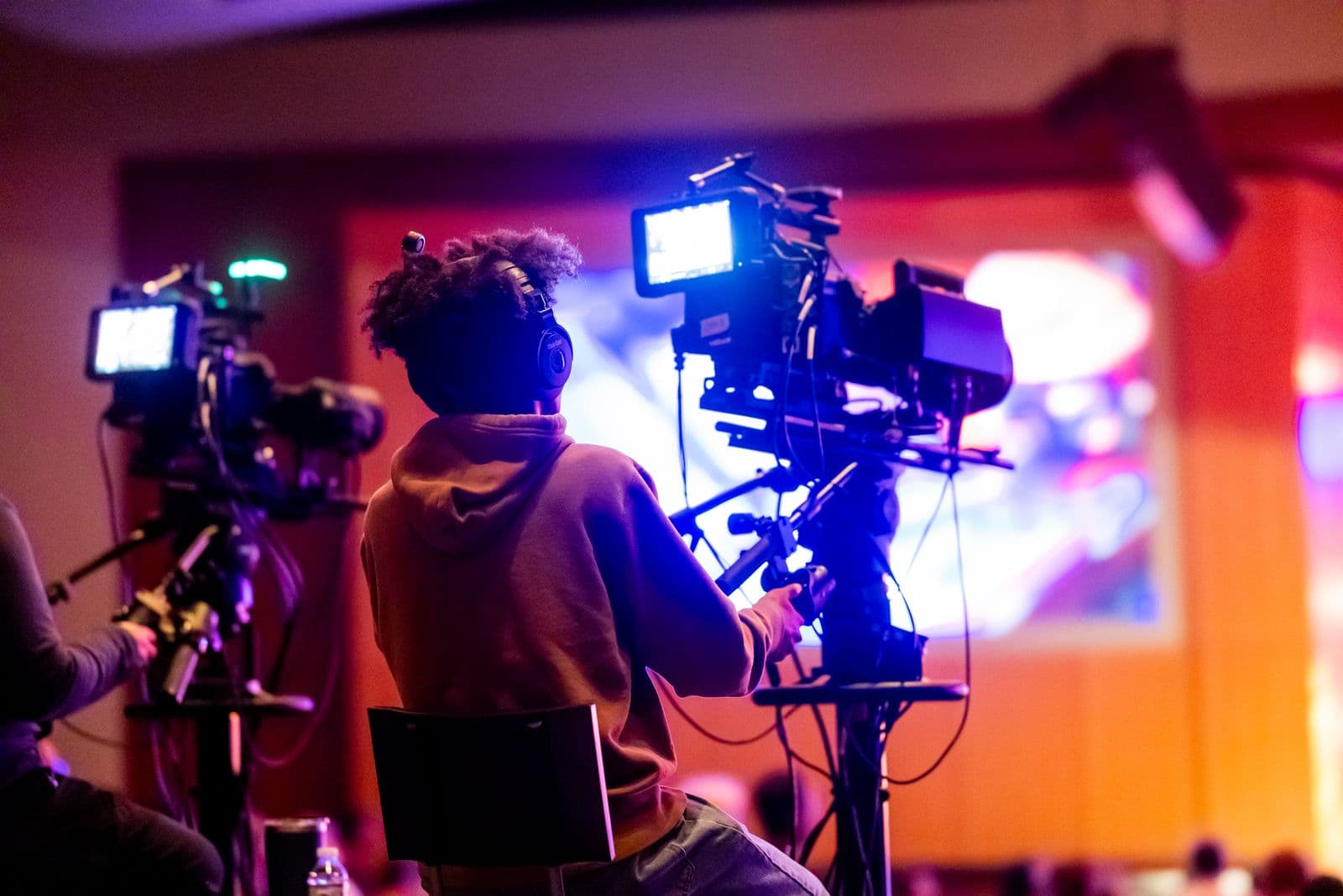 Backstage crew member wearing a headset coordinating an event production