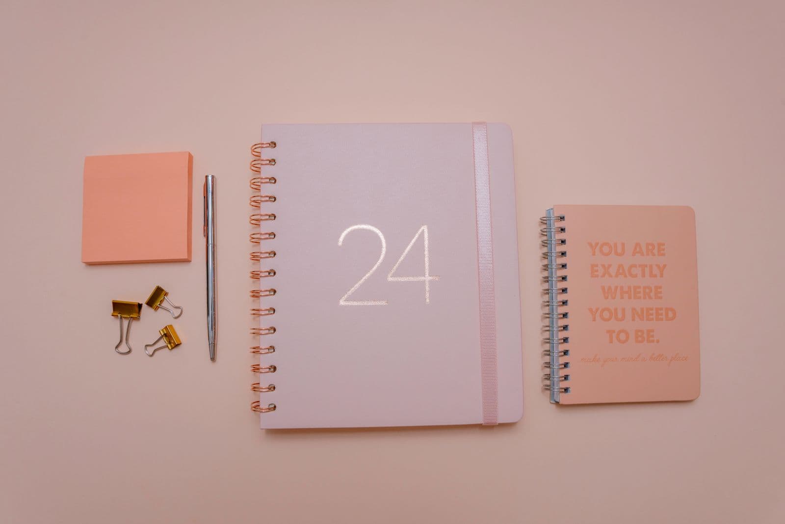 Overhead view of a desk with a calendar, notebook and pen for planning an event timeline