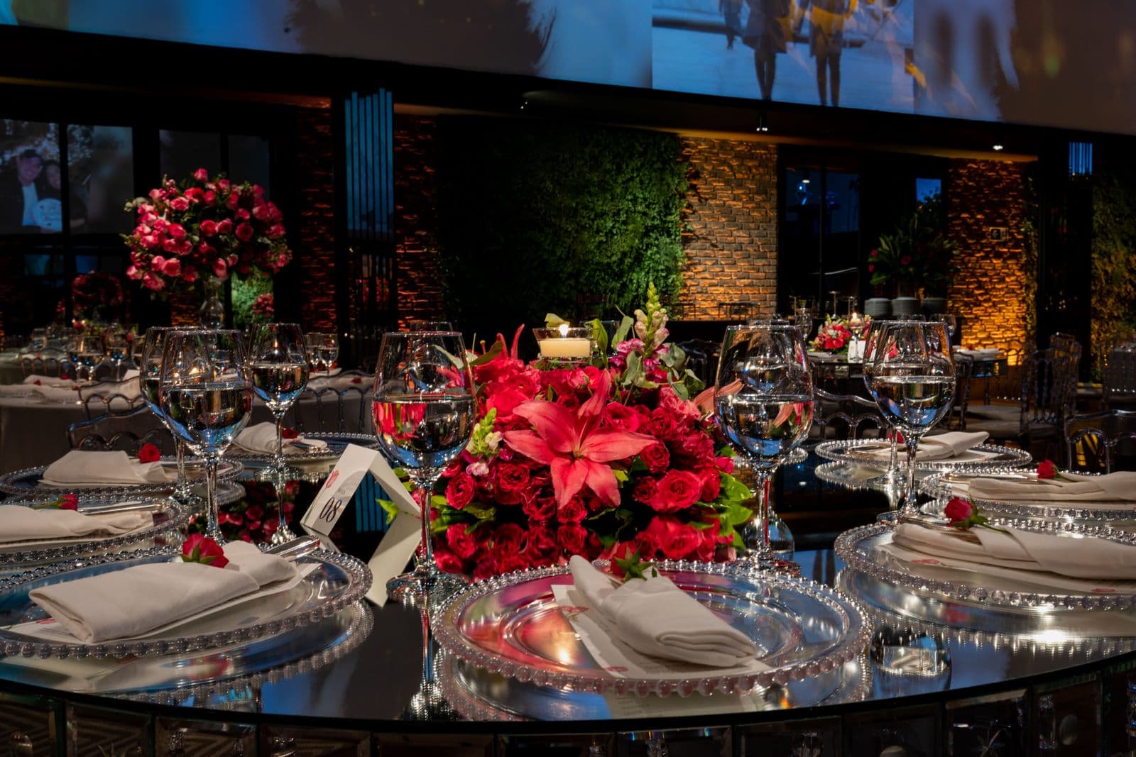 Elegant round table set with pink flower arrangements for a fundraising gala