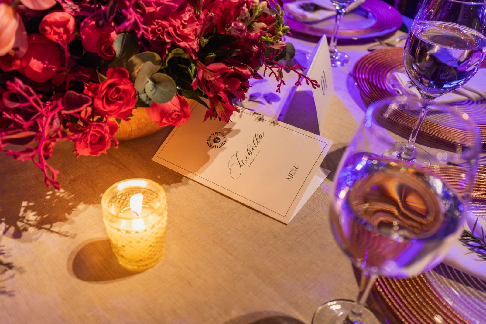 Candle and floral centerpiece on a table at an elegant nonprofit gala dinner